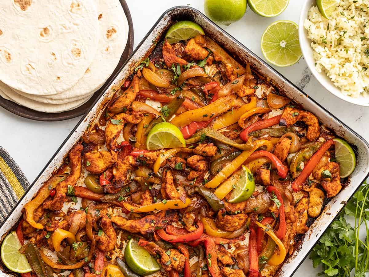 Sheet-pan chicken fajitas with roasted peppers, onion, and lime